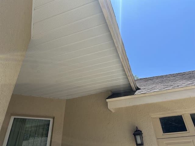 Cream vented soffit panels running out to the fascia on a stucco home.