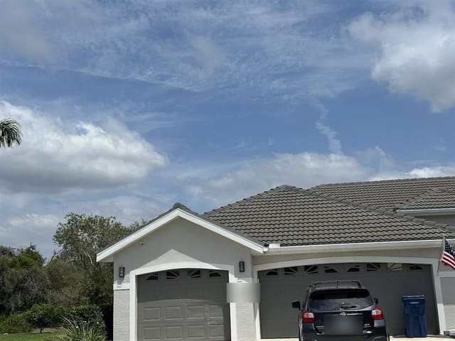 White gutter and fascia along a tile-roof garage elevation.