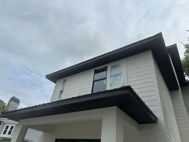 Black vented soffit under wide eaves on a new two-story home.